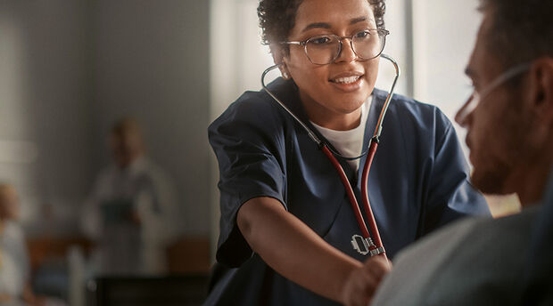 Healthcare professional uses stethoscope to listen to heartbeat 
